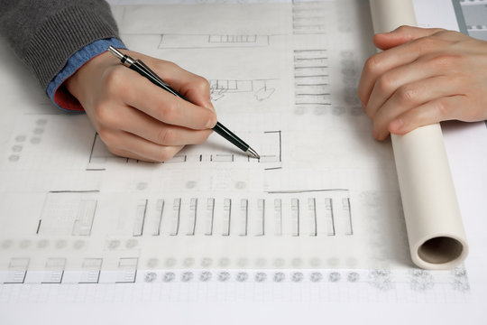Architect hand drawing building plan sketch with mechanical pencil