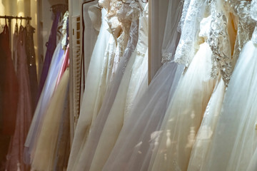 Bridal dresses behind shop window.