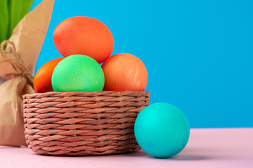Colored eggs on pink table close up. Object