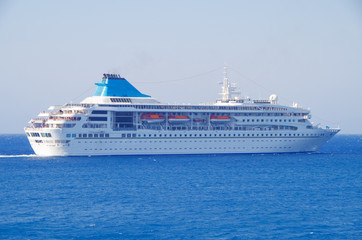 Modern cruise ship liner in the sun light against blue sea ocean and sky in summer in the...