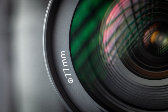 Professional photographic lens 24-105 mm polarizing filter for modern DSLR camera. Close-up macro shot of diameter for installing a photo filter 77 mm.