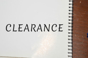 clearance word written on white paper
