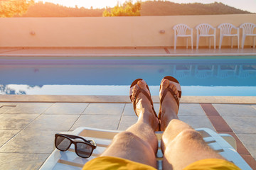 Enjoying summer time vacation near the swimming pool.