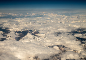Naklejka premium Top View from plane to snow capped peaks of Caucasus Mountains