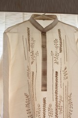 Close up of a barong Tagalog for the groom, an embroidered formal shirt and a national dress of the Philippines.