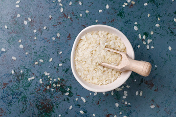Rice flakes,rice noodles,rice bread and rice on dark background,top view