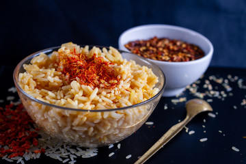 rice in a glass dish with saffron, red hot pepper