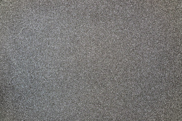 Gray giltter texture abstract background. Shiny wrapper paper.