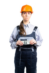 a girl in work clothes, looks very sad because of the money. She holds dollars in her hands. Isolated