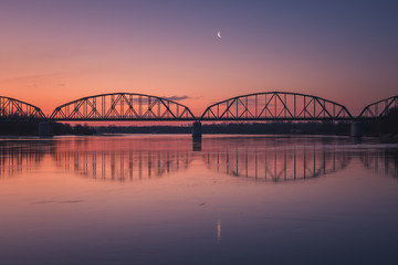 Fototapeta na wymiar Trailway bridge over the Vistula river at night in Gora Kalwaria, Poland