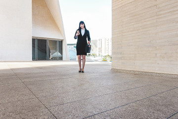 Business asian woman out of the office building using smartphone app - Young female worker going to work - Tech, entrepreneur and job concept - Focus on her face