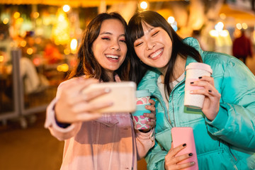 Happy asian friends making video with smartphone for social network app - Young women having fun...