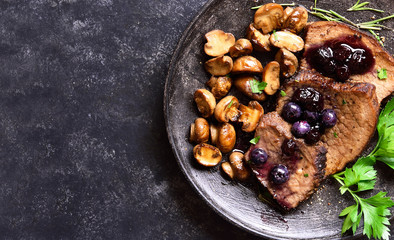 Beef with mushrooms and blueberry sauce