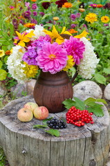 Fototapeta na wymiar bouquet of flowers in basket on wooden background