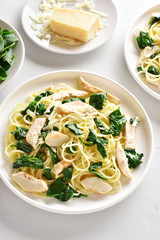 Spaghetti with spinach leaves, grilled chicken breast and cheese