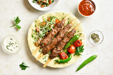 Adana Kebab with fresh vegetables on flatbread
