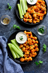 Cauliflower buffalo wings with celery and sauce