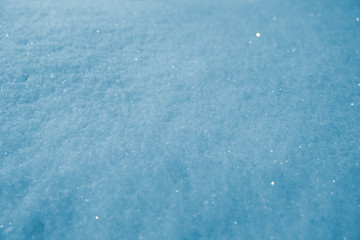 Glittering snow texture background, toned.