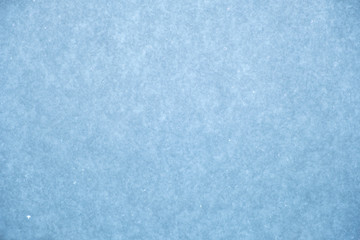 Glittering snow texture background, toned.
