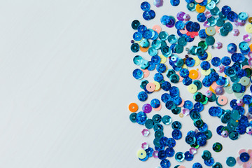 Colored and blue sequins on a white background