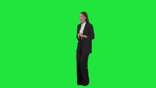 Excited surprised happy business woman looking away with astonished reaction. Full length on green screen background