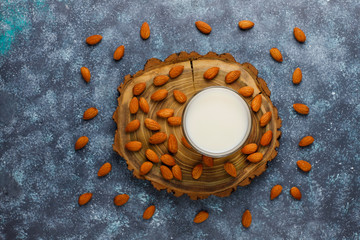 Almond milk with almond on dark grey background,top view