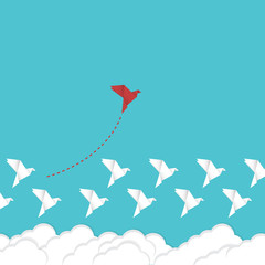 Think differently concept. Be different. Red bird changing direction. New idea, change, trend, courage, creative solution, innovation and unique way concept.