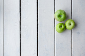 green apples on a background of wooden boards