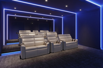 3d home cinema room with blue light and beige leather armchairs - obrazy, fototapety, plakaty
