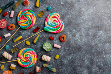 Colorful candies, jelly and marmalade on dark grey background,top view