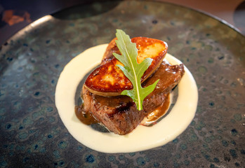 Foie gras Wagyu fusion Beef Steak grilled on black stone plate.