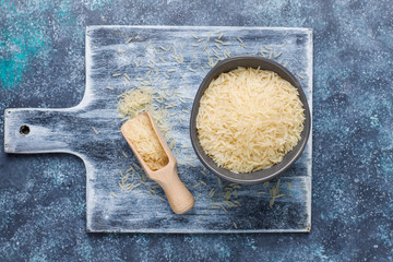Fototapeta na wymiar Rice flakes,rice noodles,rice bread and rice on dark background,top view