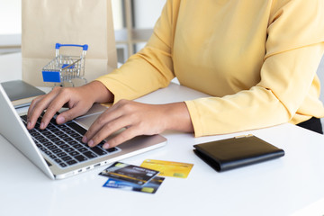 Women use laptop register via credit cards to make online purchases, Online shopping or Internet technology concept.