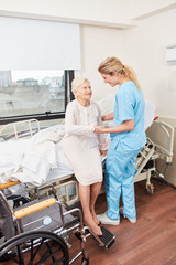 Nursing lady cares for disabled senior citizen