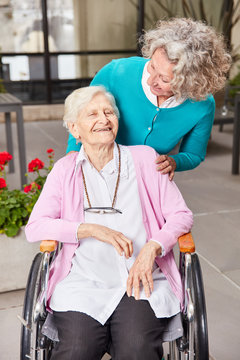 Daughter As A Visitor And Mother In A Wheelchair