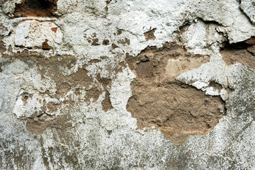 Old damaged brick wall with plaster background texture.