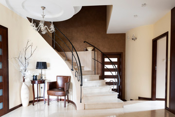 Modern interior of marble staircase with marble stairs and design banister.  Luxury apartment as a...