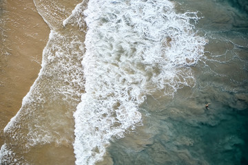 Fototapeta na wymiar Aerial View of Waves and Azure beach with rocks. Kerala, India.