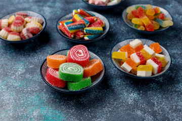 Colorful candies, jelly and marmalade on dark grey background,top view