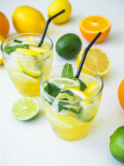 Citrus cold lemonade with lime, mint and lemons in glasses