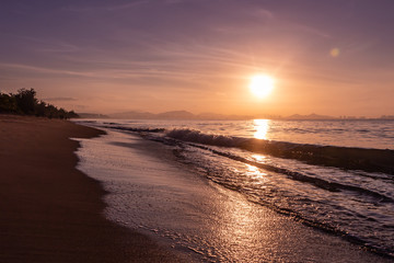 Beautiful orange sunrise is on the beach by the sea