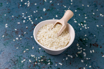 Rice flakes,rice noodles,rice bread and rice on dark background,top view