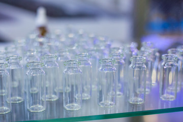 Pharma industry, science, medicine, experiment, chemistry, research and healthcare concept. Medical empty glass bottles in showcase at pharmaceutical exhibition, pharmacy laboratory