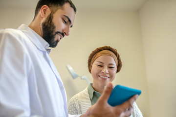 Fototapeta premium Bearded young doctor and his patient talking