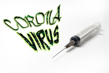 syringe on white background and text coronavirus