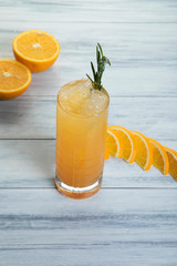Orange Mojitto made with gin, mint leaves, orange and lime wedges topped with sodath Gin