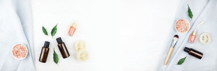 Banner made from homemade spa cosmetic set with salt and oil on white wooden background. Copy space. Flat lay style.