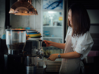 Asian woman with coffee in cafe