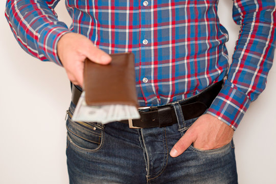 a man holds dollars in his hands