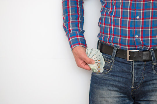 a man holds dollars in his hands